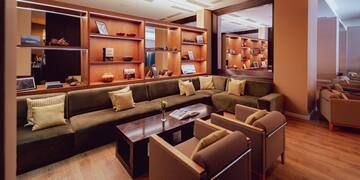 a room with a couch and chairs