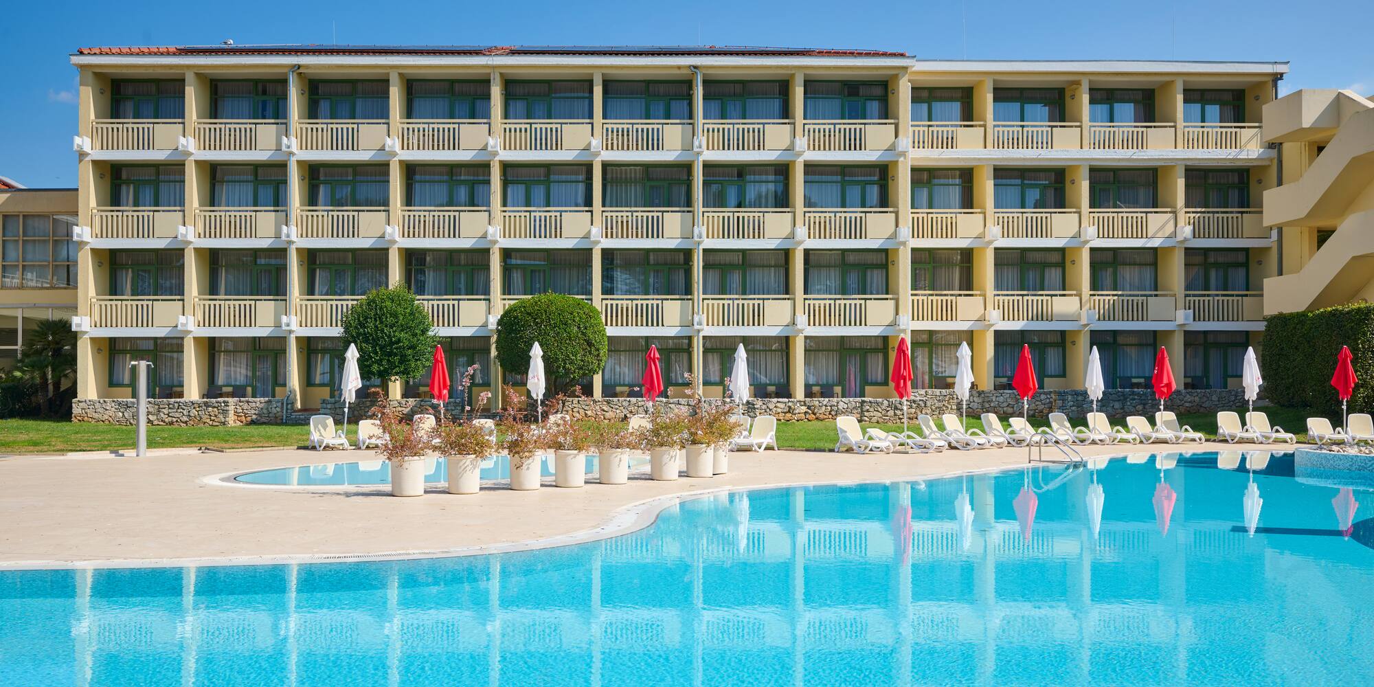 a swimming pool with a building in the background