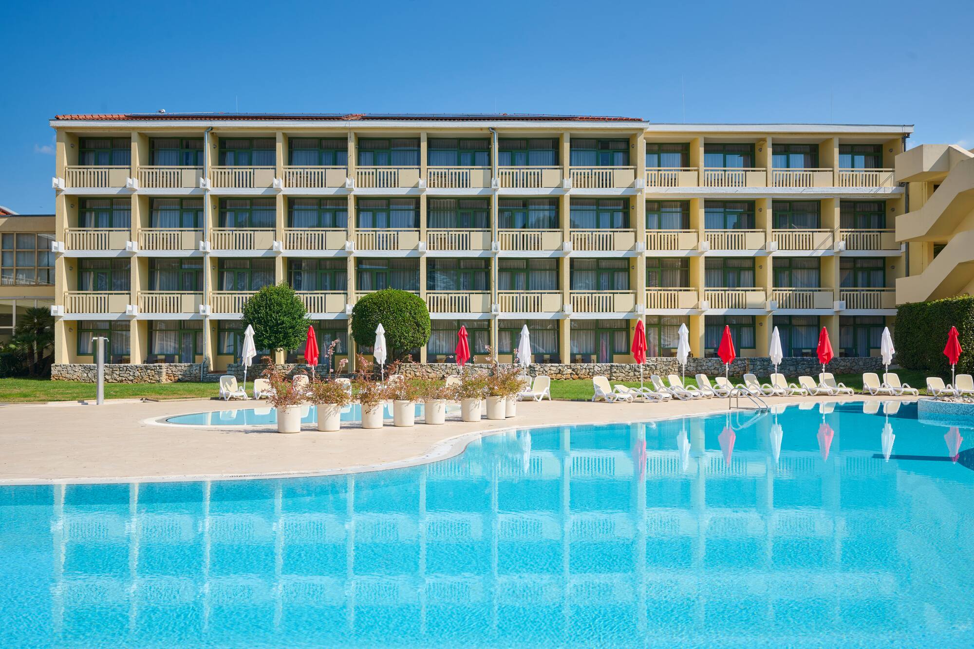 a swimming pool with a building in the background