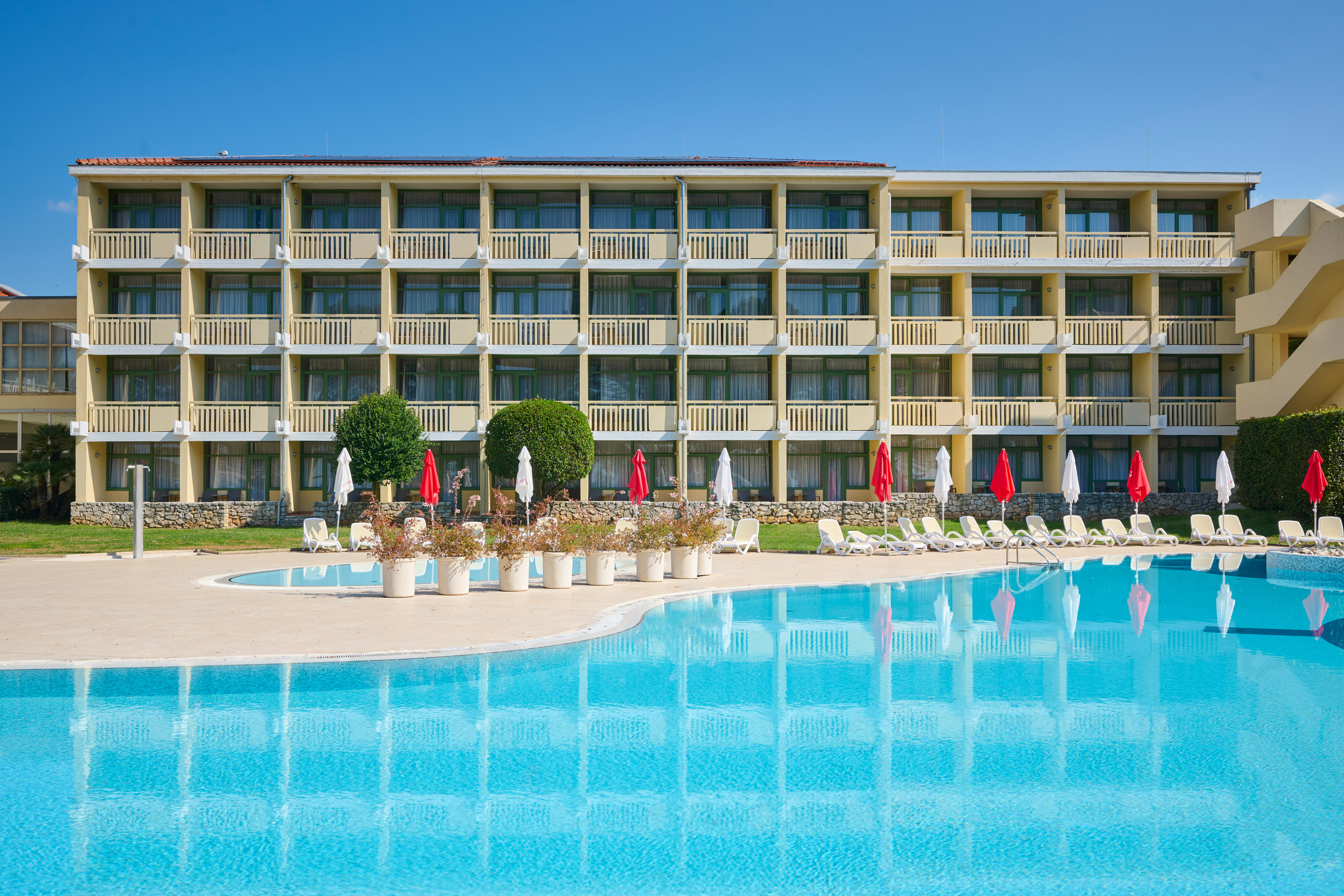 a swimming pool with a building in the background