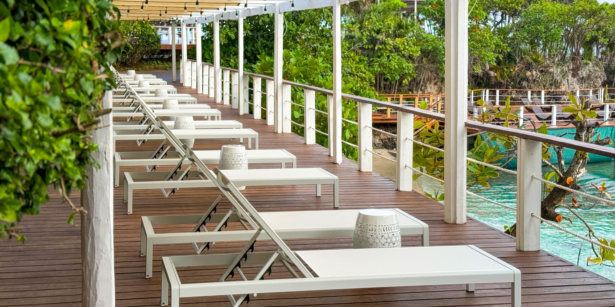 a deck with chairs and a pool
