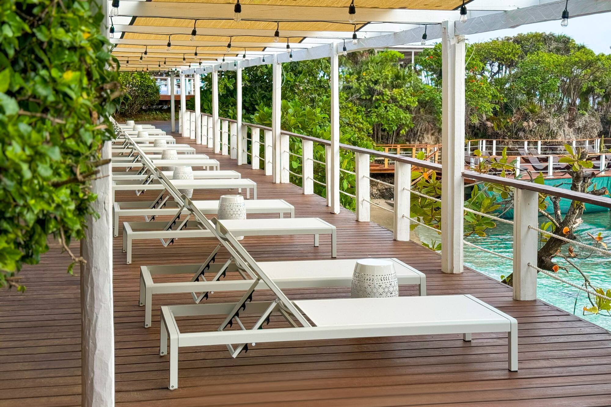 a deck with chairs and a pool