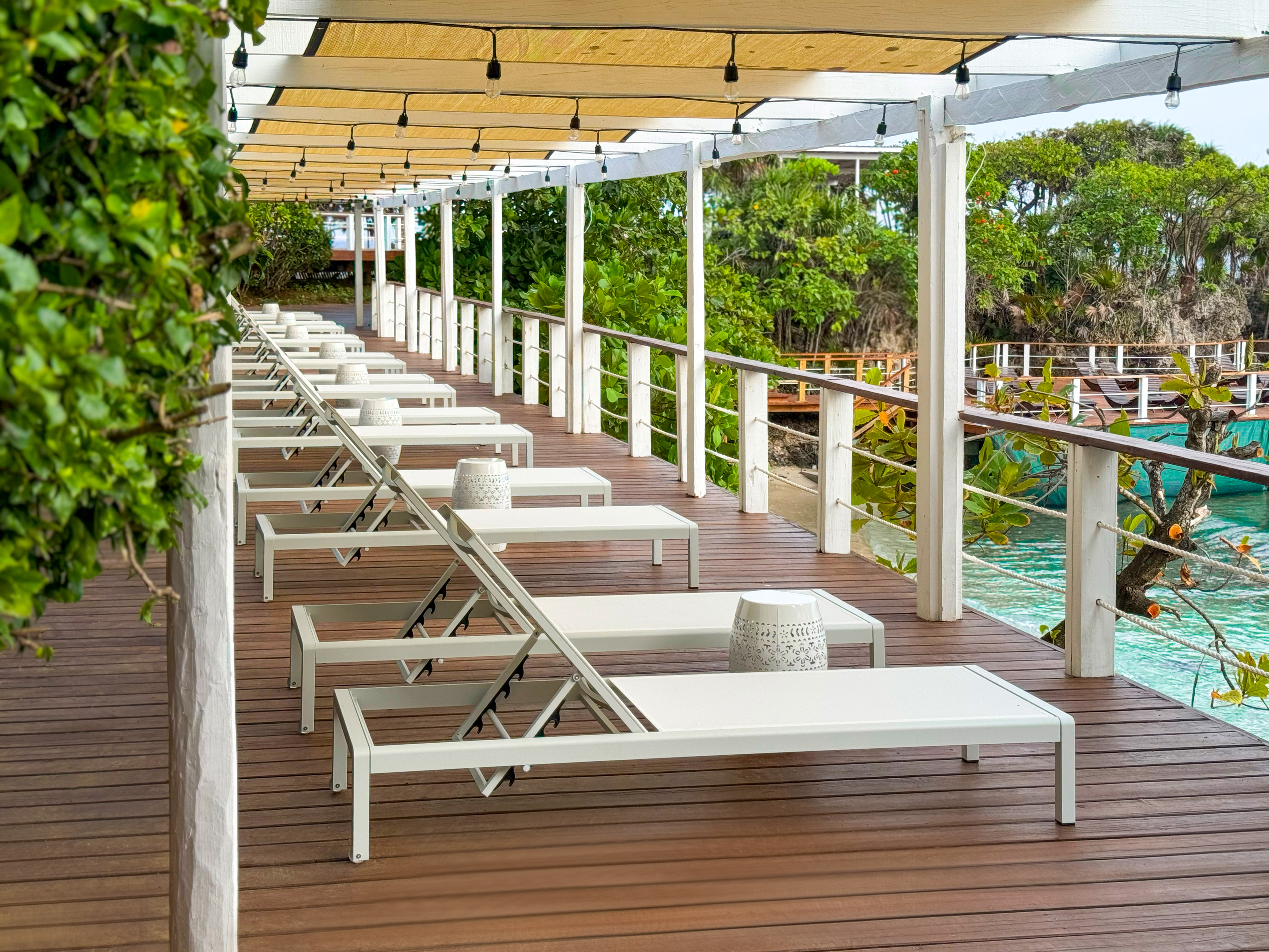 a deck with chairs and a pool