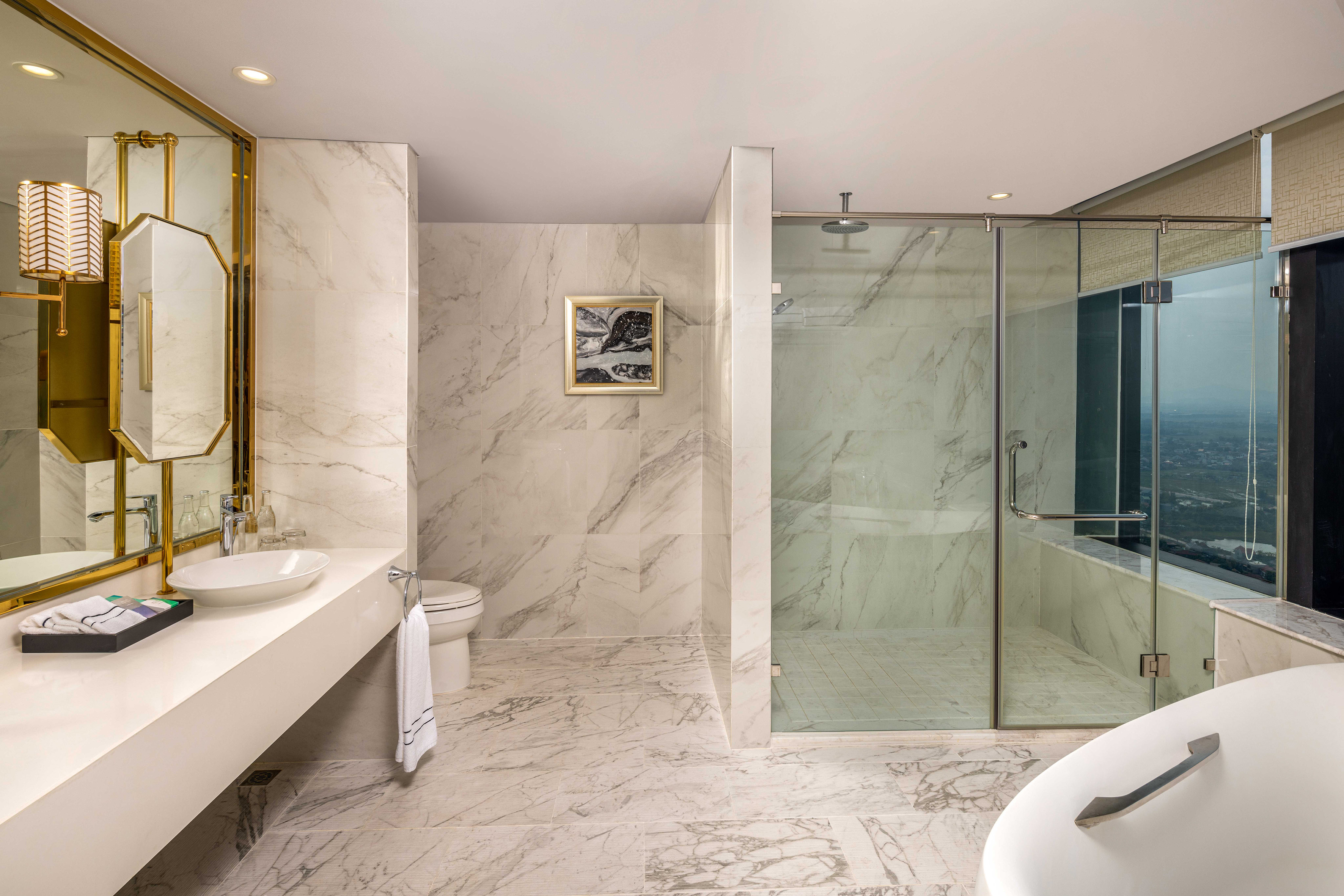 a bathroom with marble walls and a sink and shower