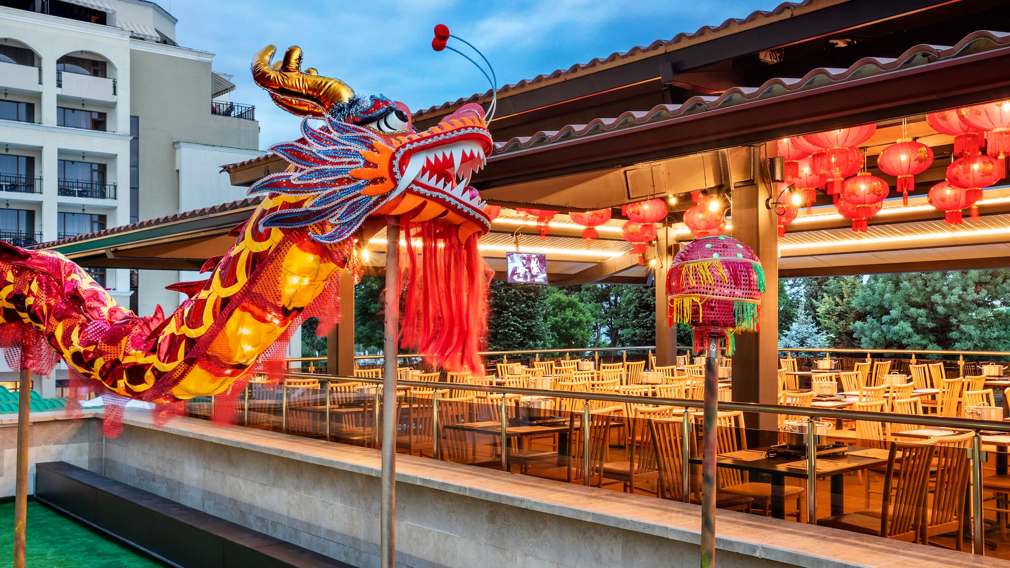 a large red and yellow dragon statue outside a restaurant