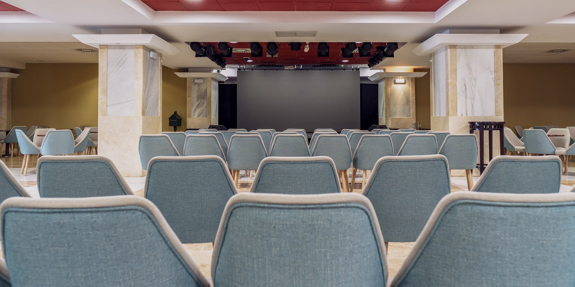 a room with chairs and a screen