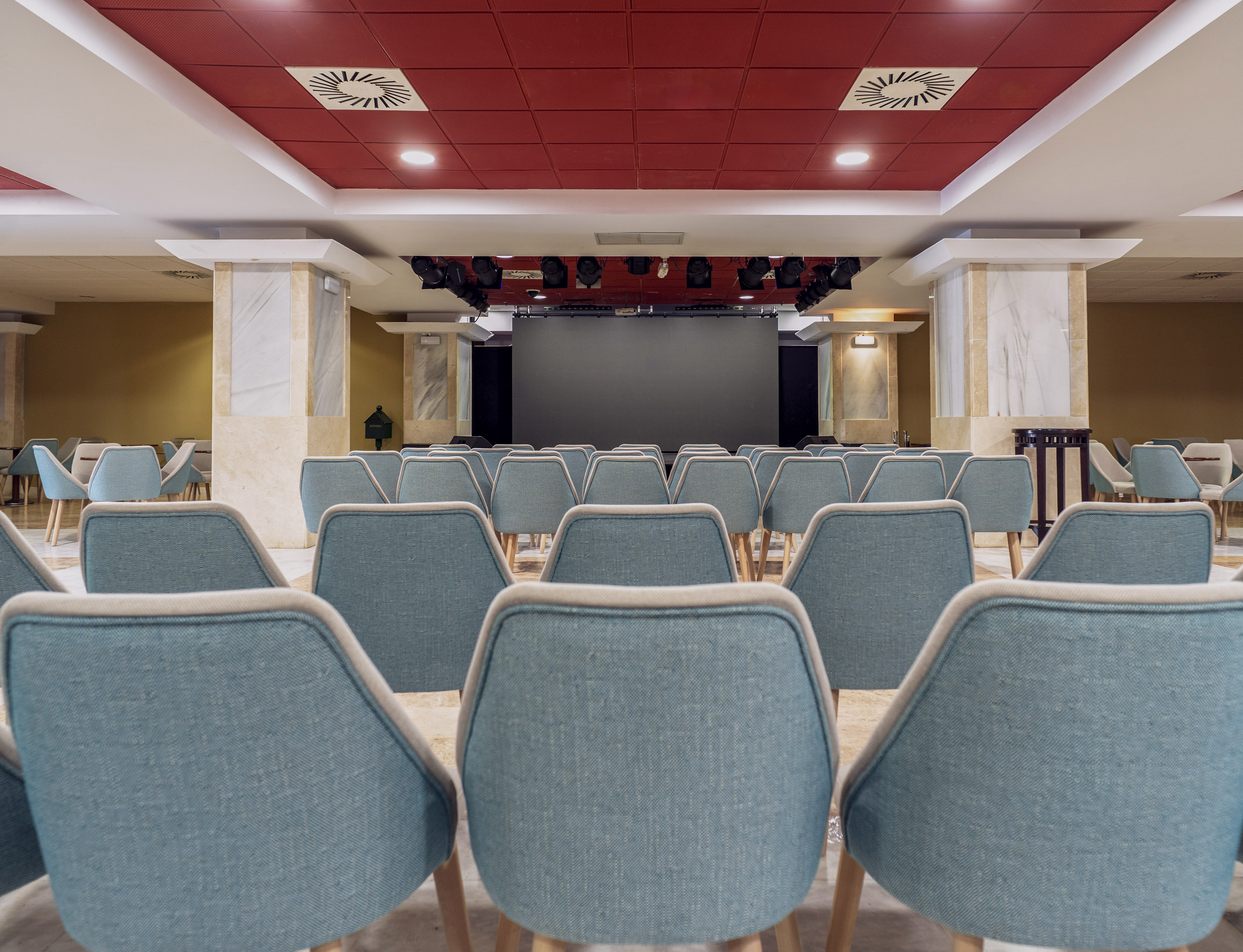 a room with chairs and a screen