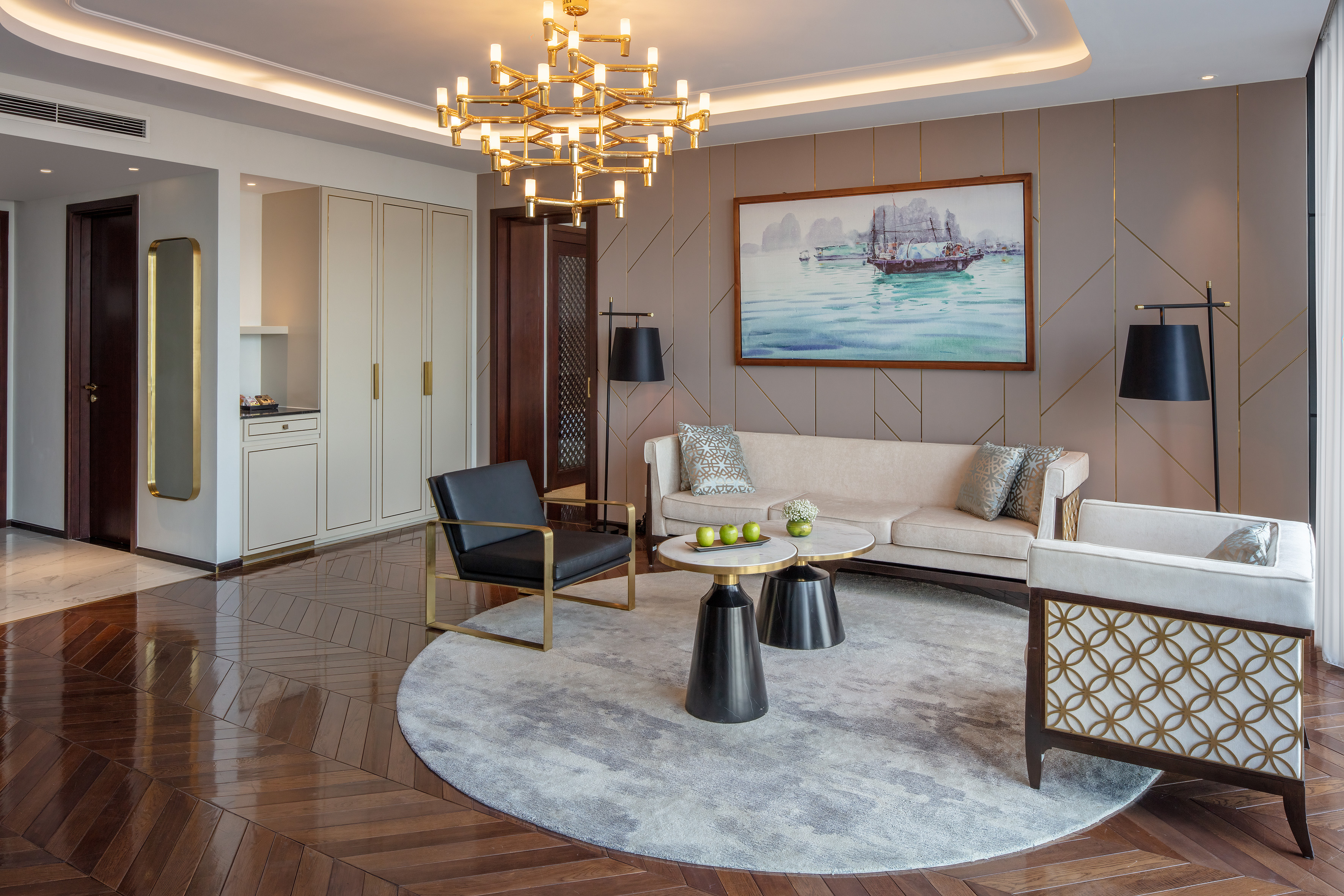 Luxury living room with gold chandelier, modern furniture, and contemporary decor.
