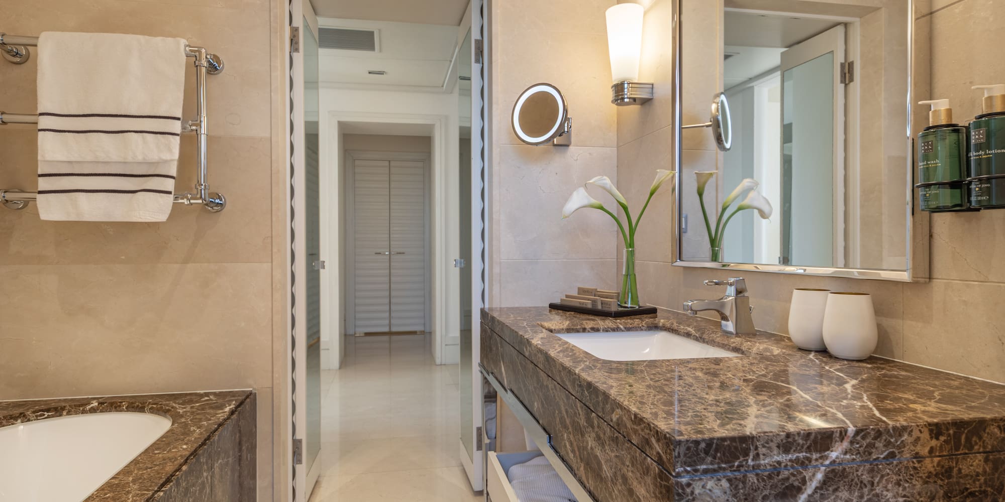 a bathroom with marble countertop and sink