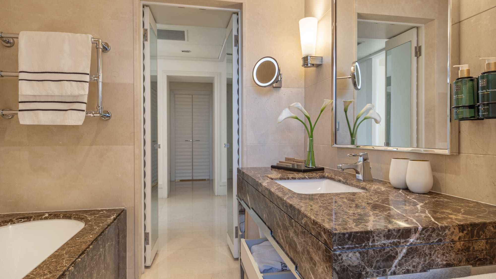 a bathroom with marble countertop and sink