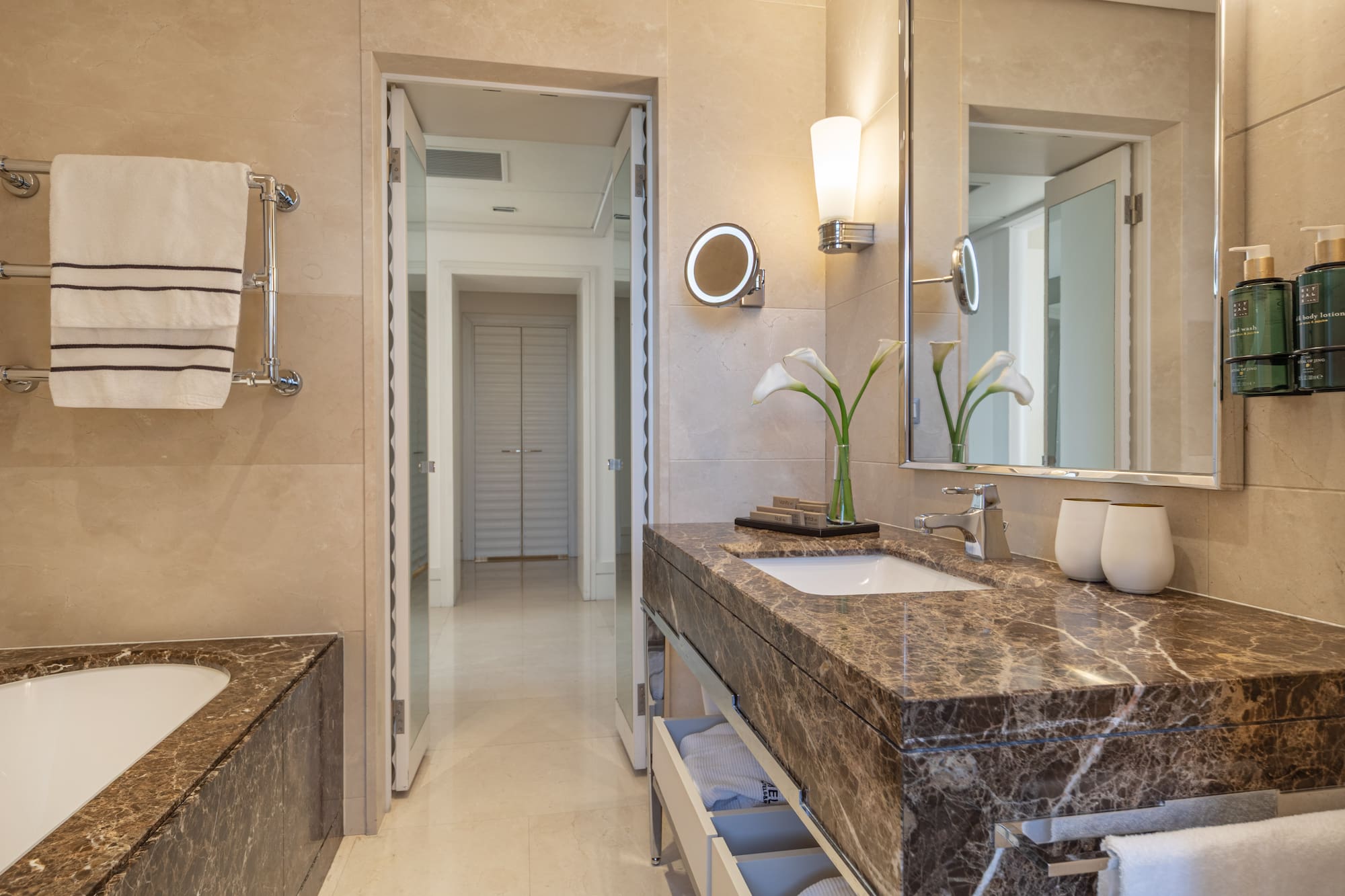 a bathroom with marble countertop and sink