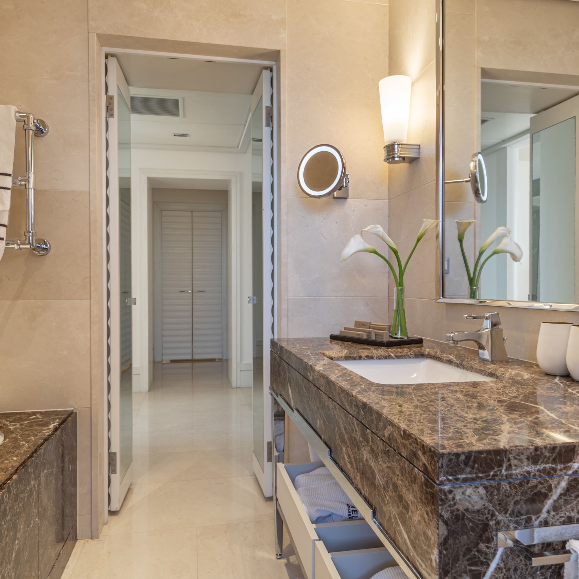 a bathroom with marble countertop and sink