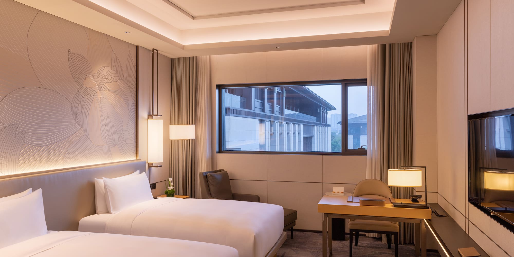 a room with two beds and a desk