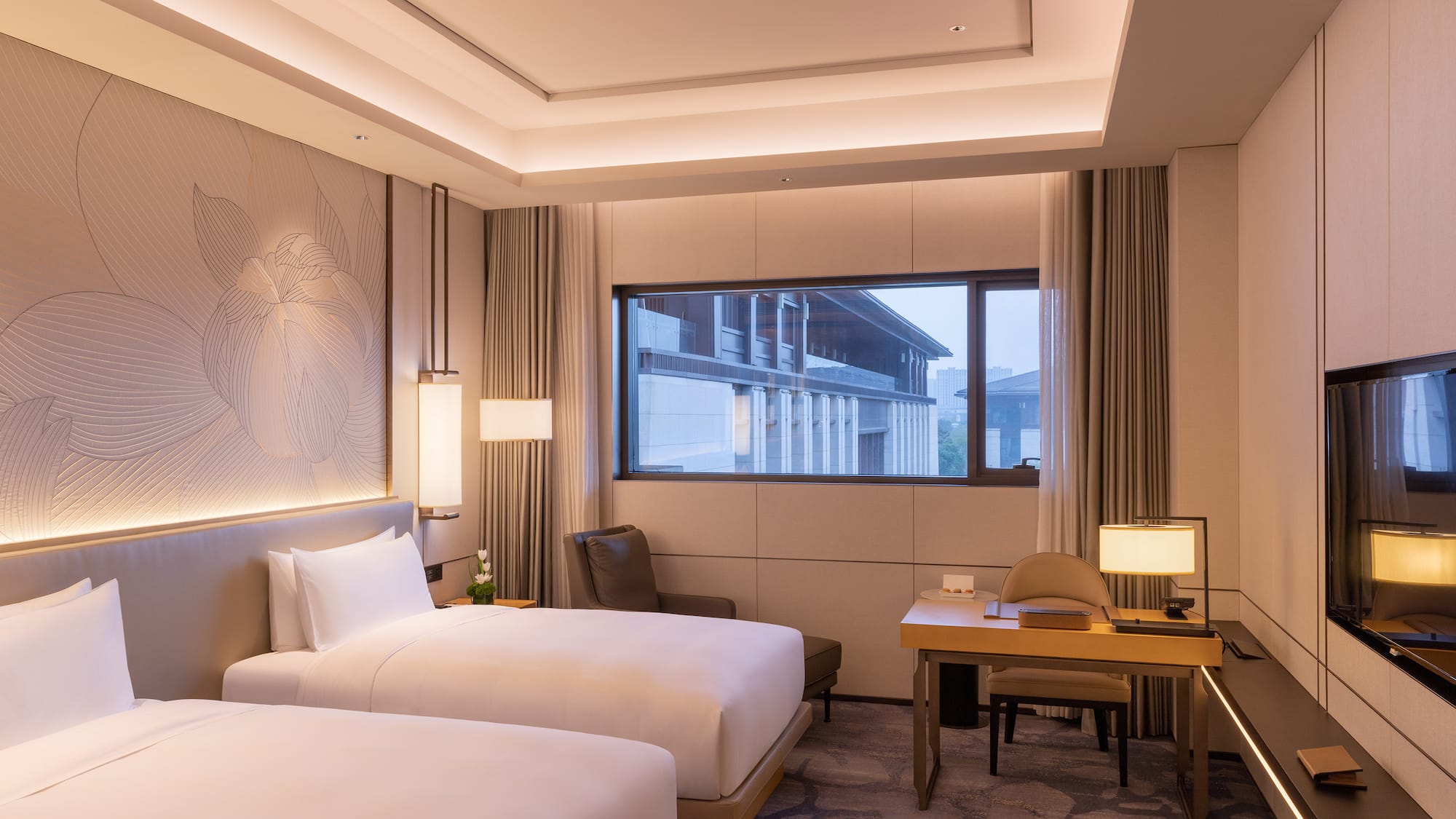 a room with two beds and a desk