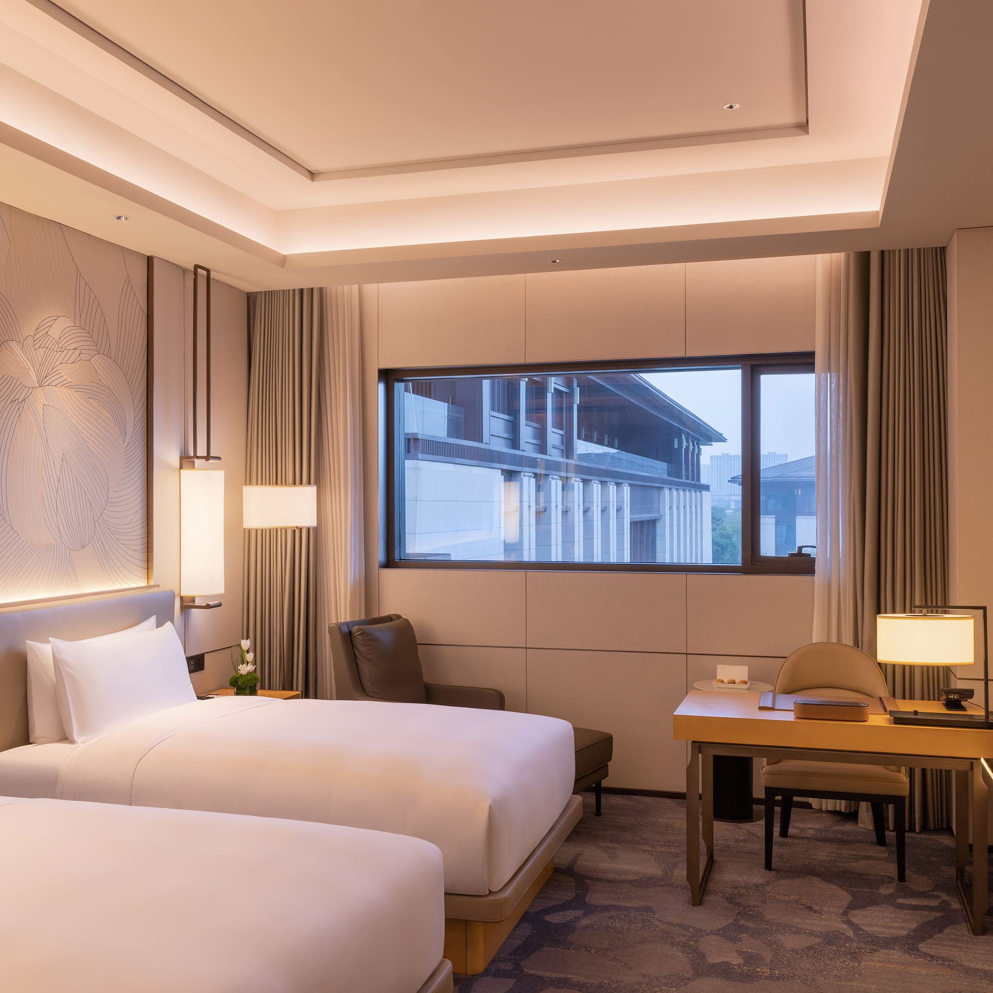 a room with two beds and a desk