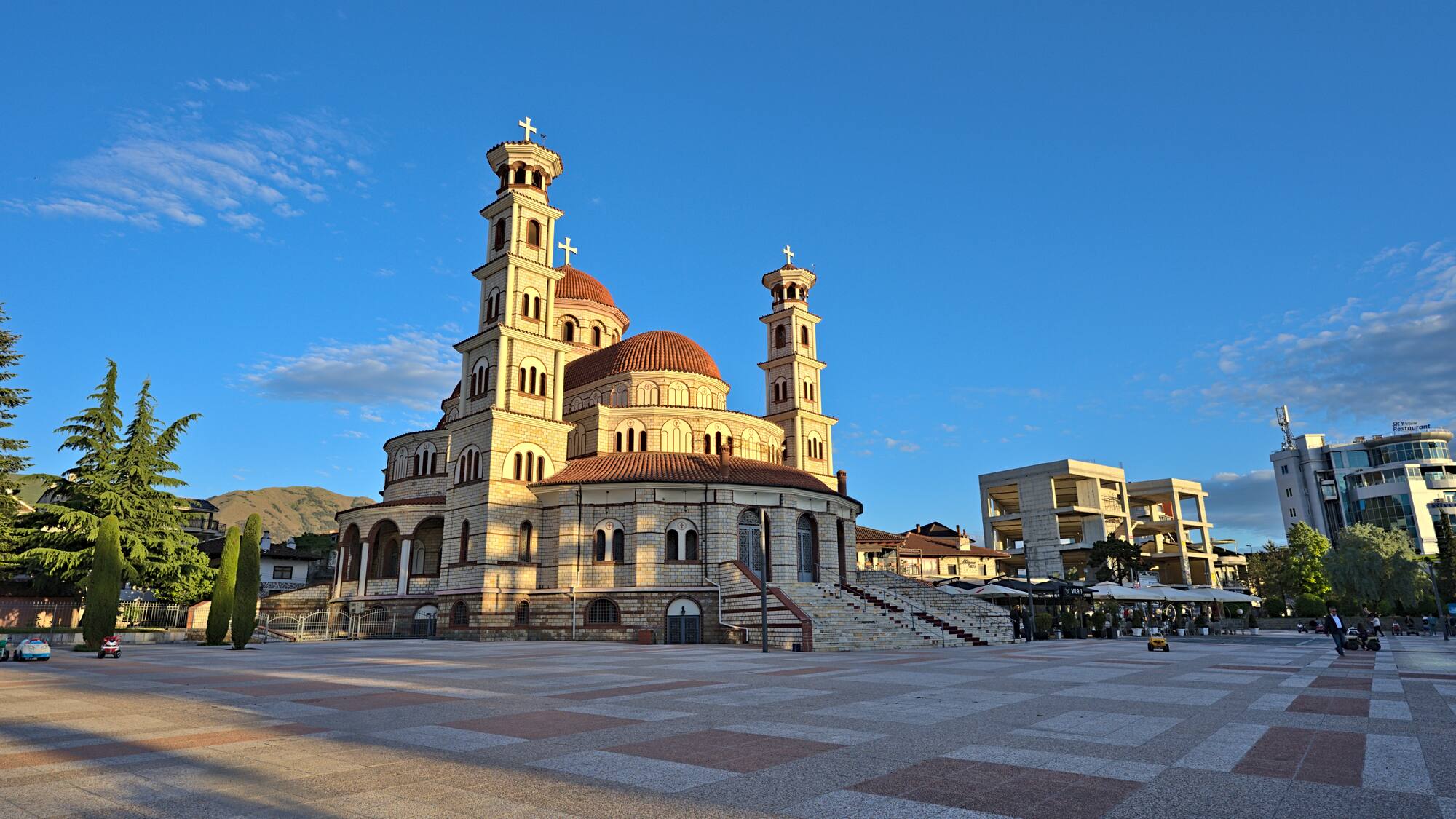 a large building with towers and a stone walkway