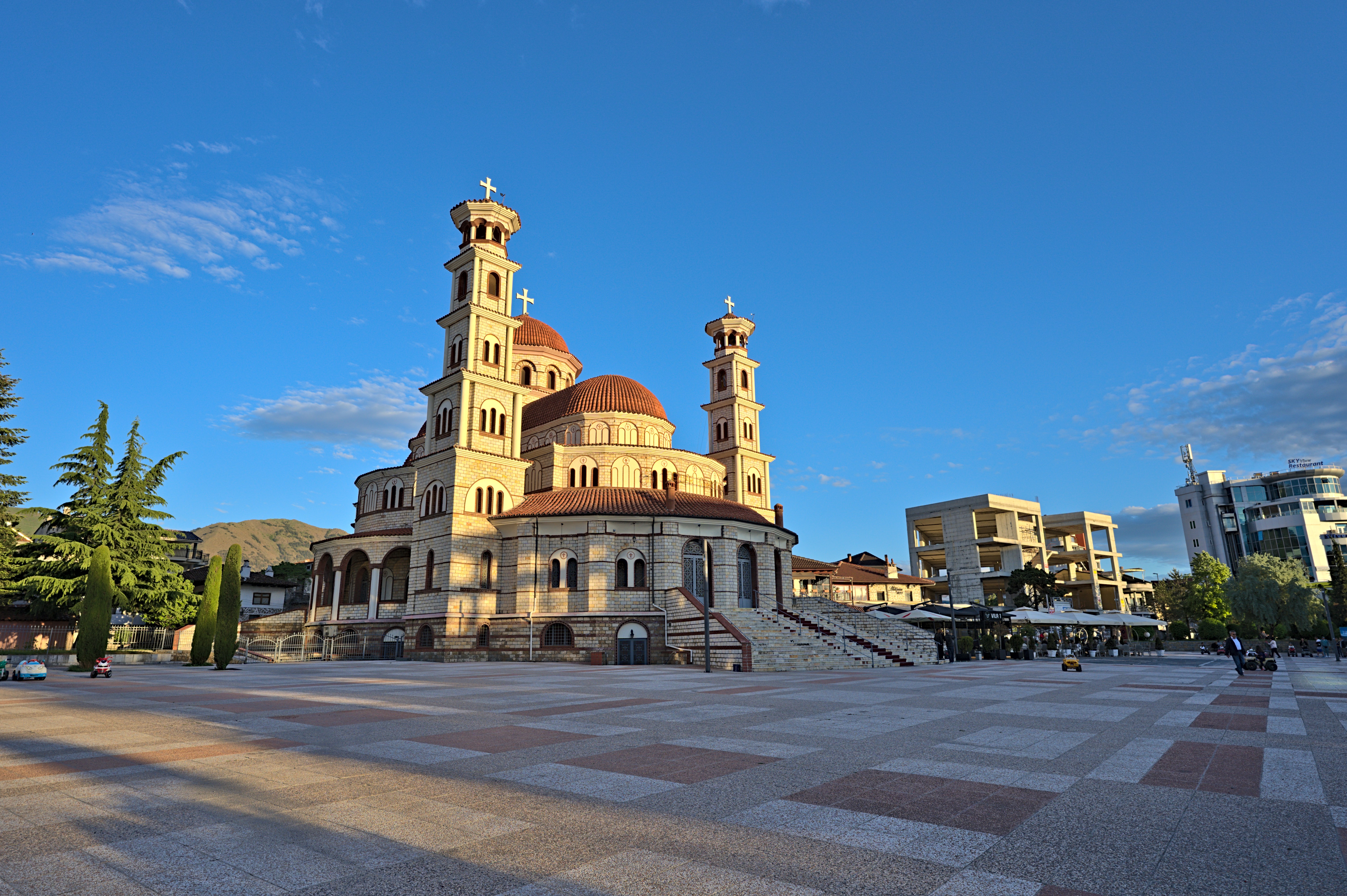 a large building with towers and a stone walkway