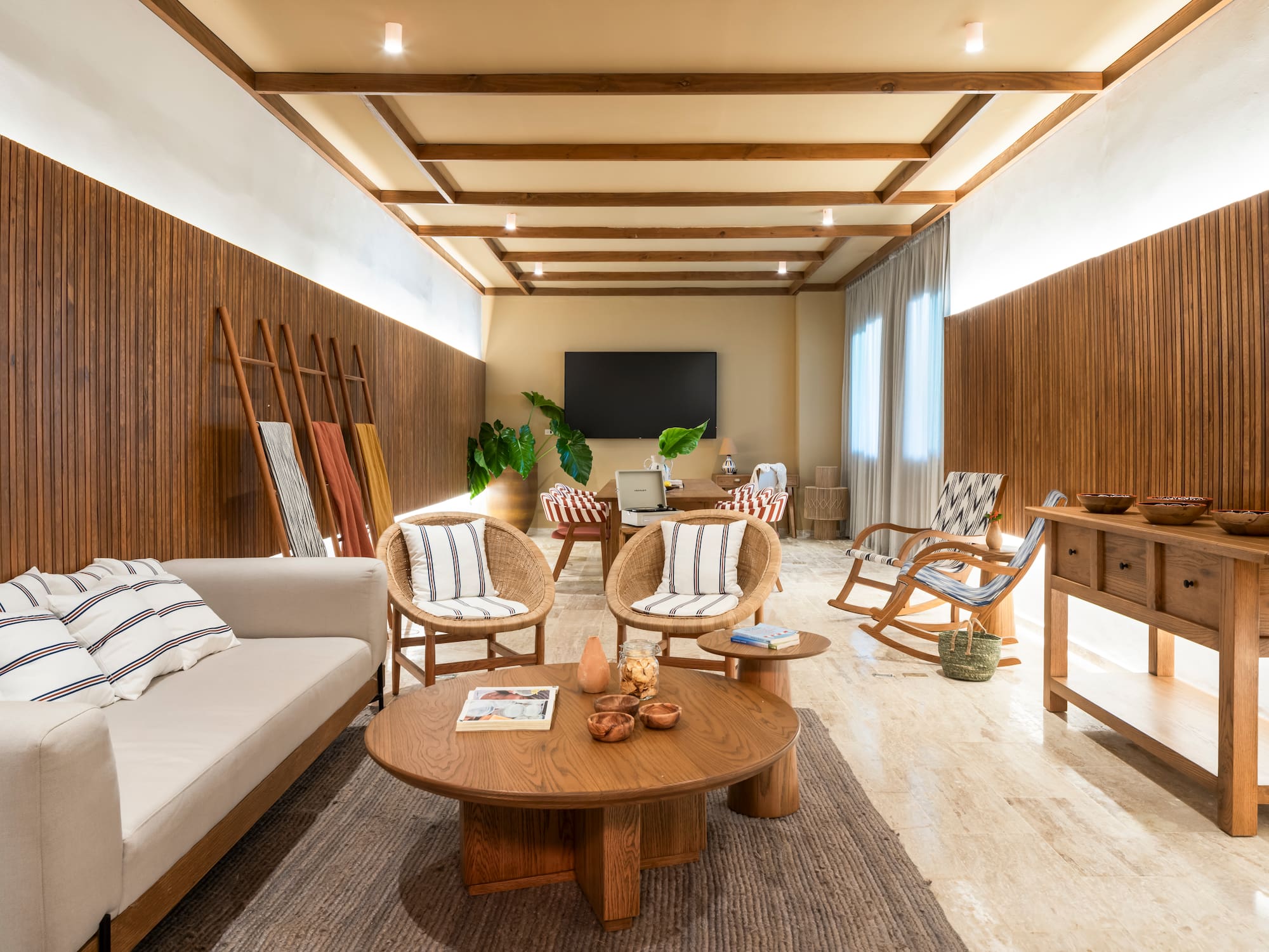 Natural modern living room with wood panels, rattan chairs, and wooden furniture.