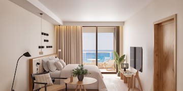 a bedroom with a bed and a table and chairs
