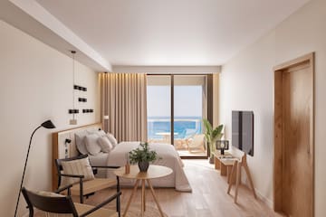 a bedroom with a bed and a table and chairs