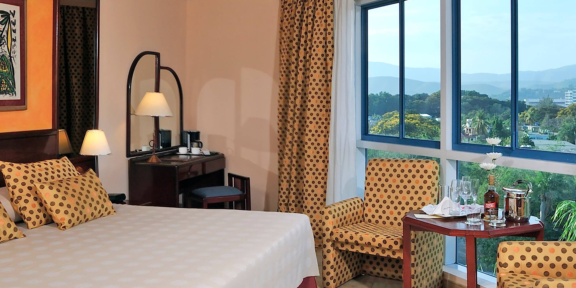 a room with a bed and chairs