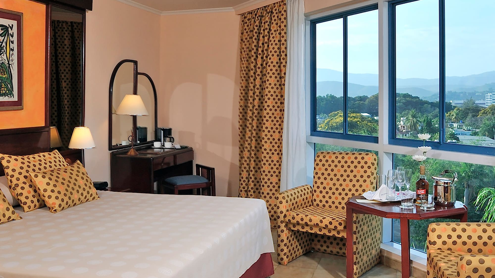 a room with a bed and chairs