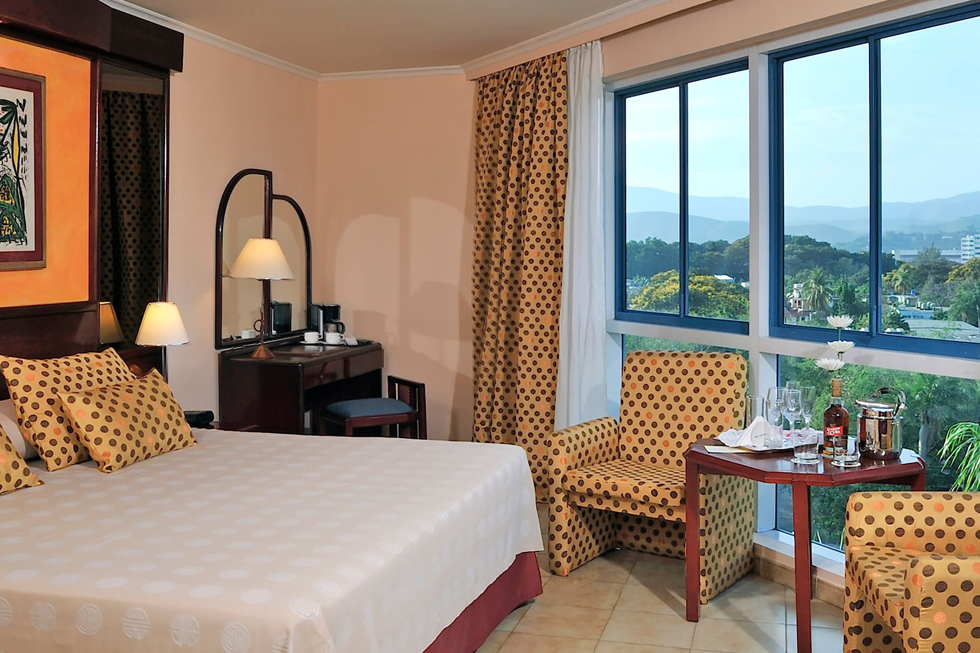 a room with a bed and chairs