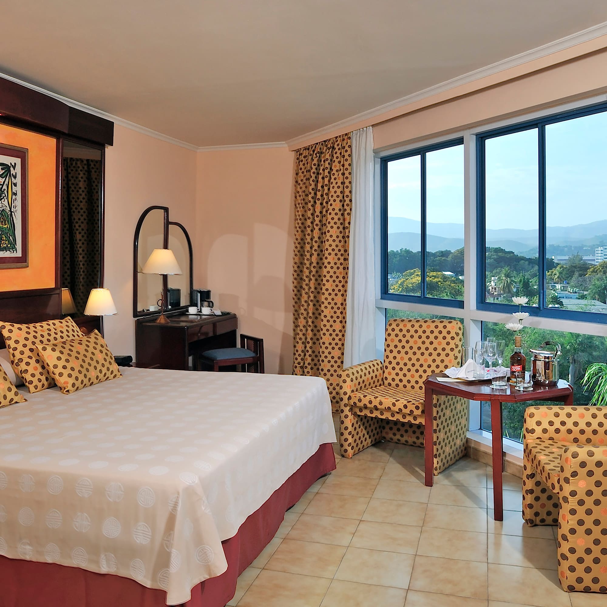 a room with a bed and chairs