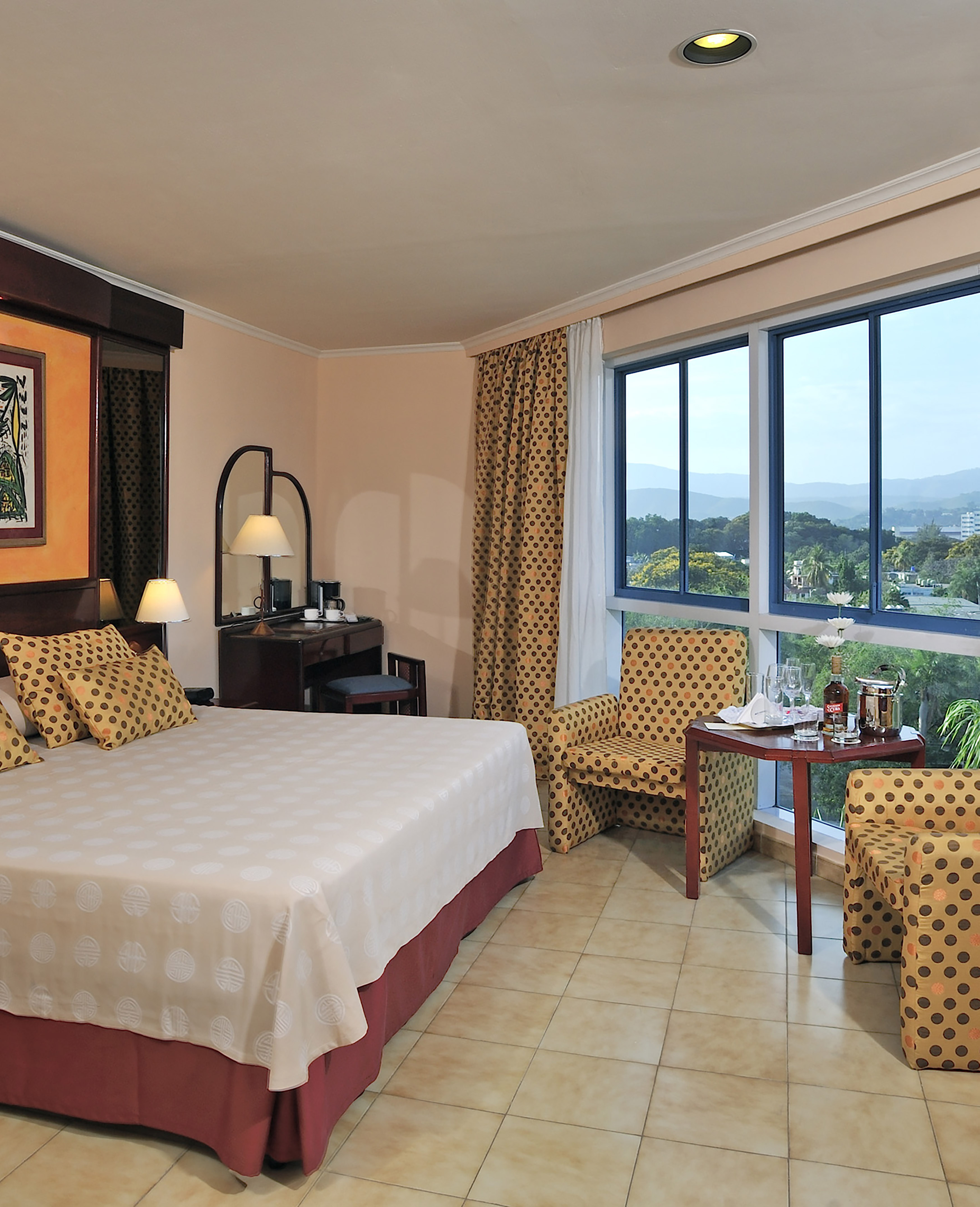 a room with a bed and chairs