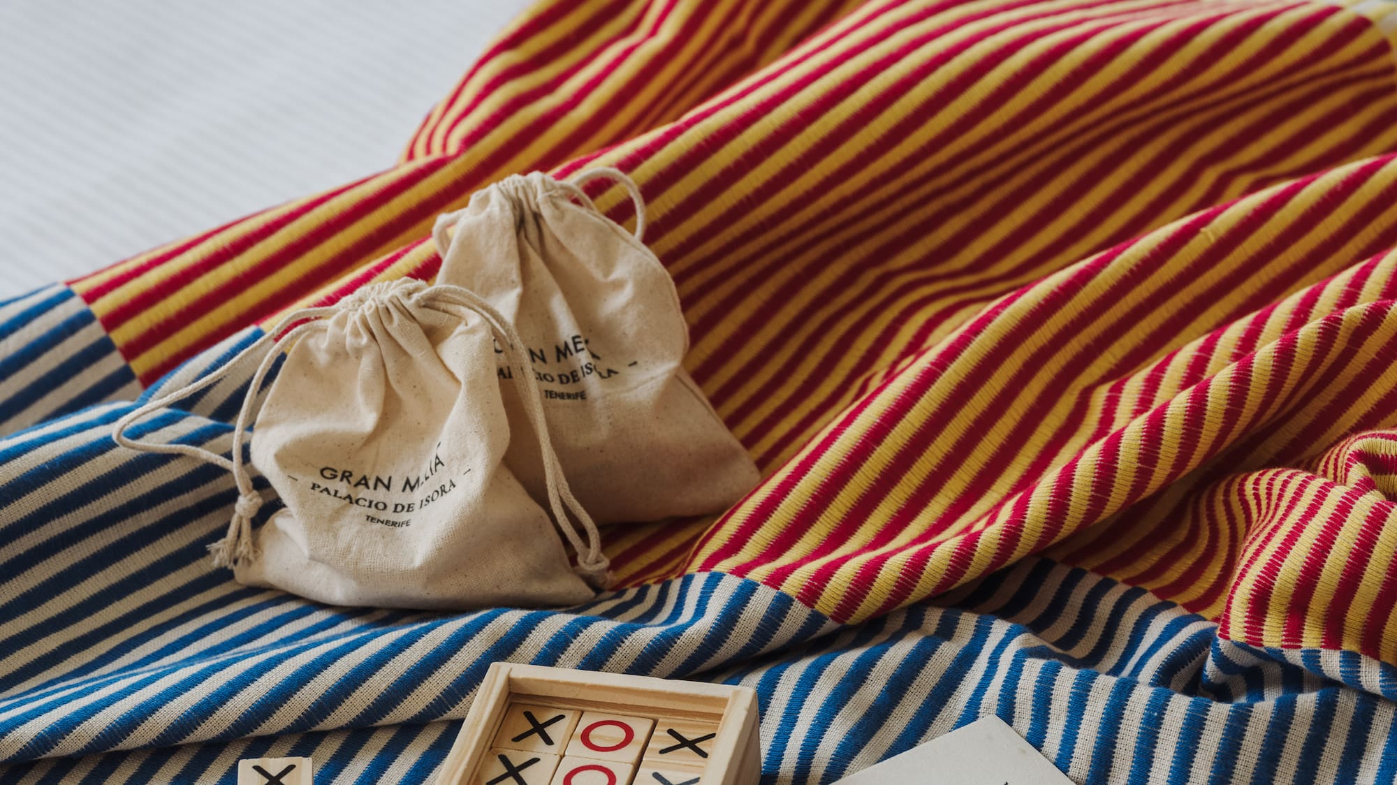 a wooden blocks and bags on a bed