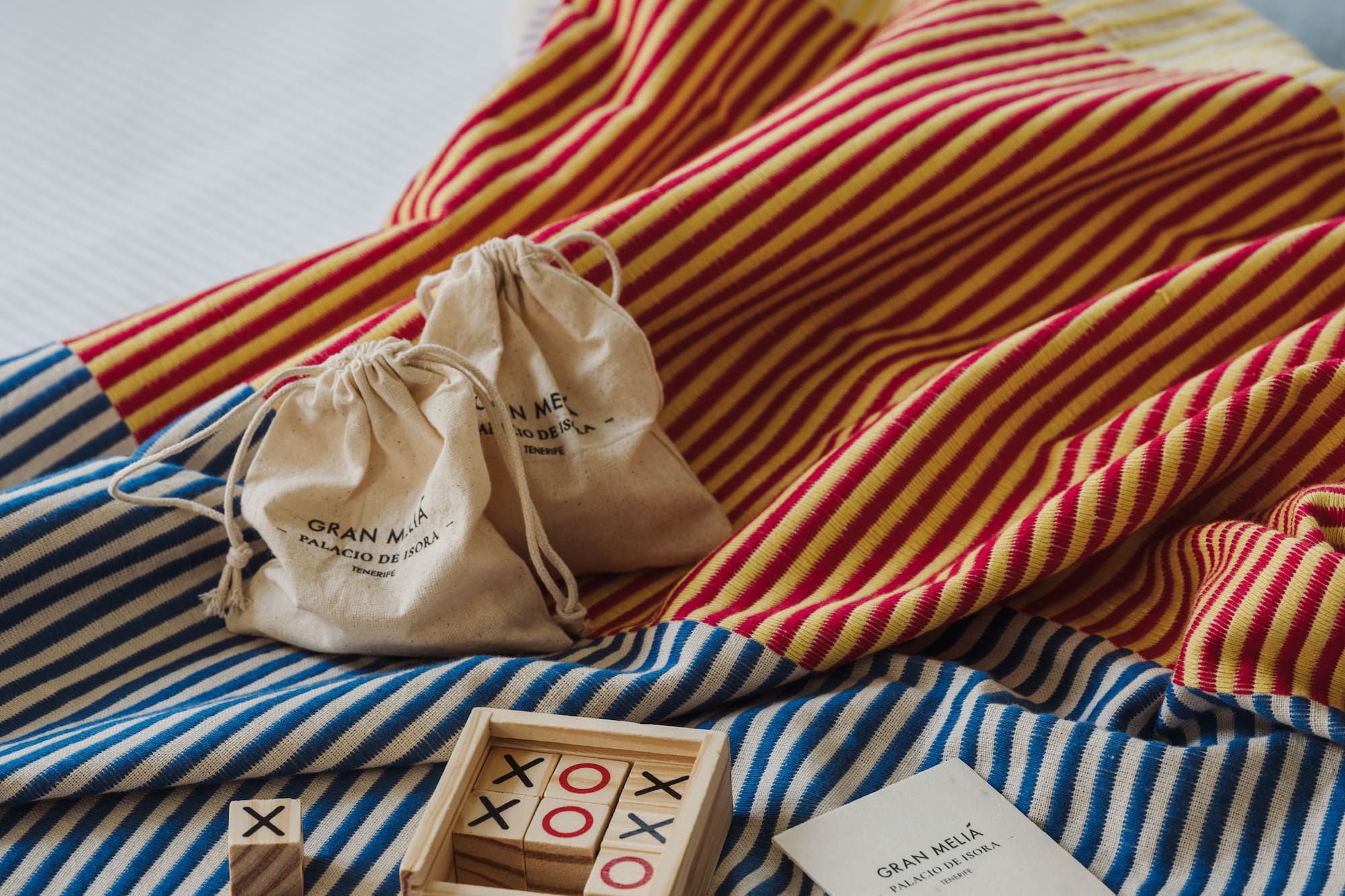 a wooden blocks and bags on a bed
