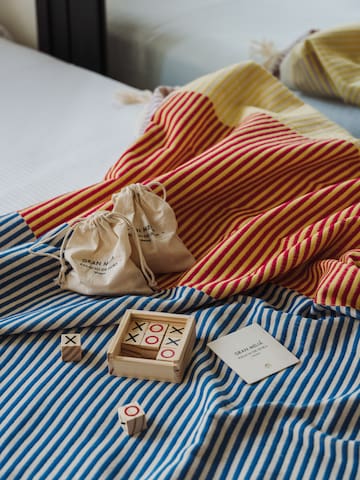 a wooden blocks and bags on a bed