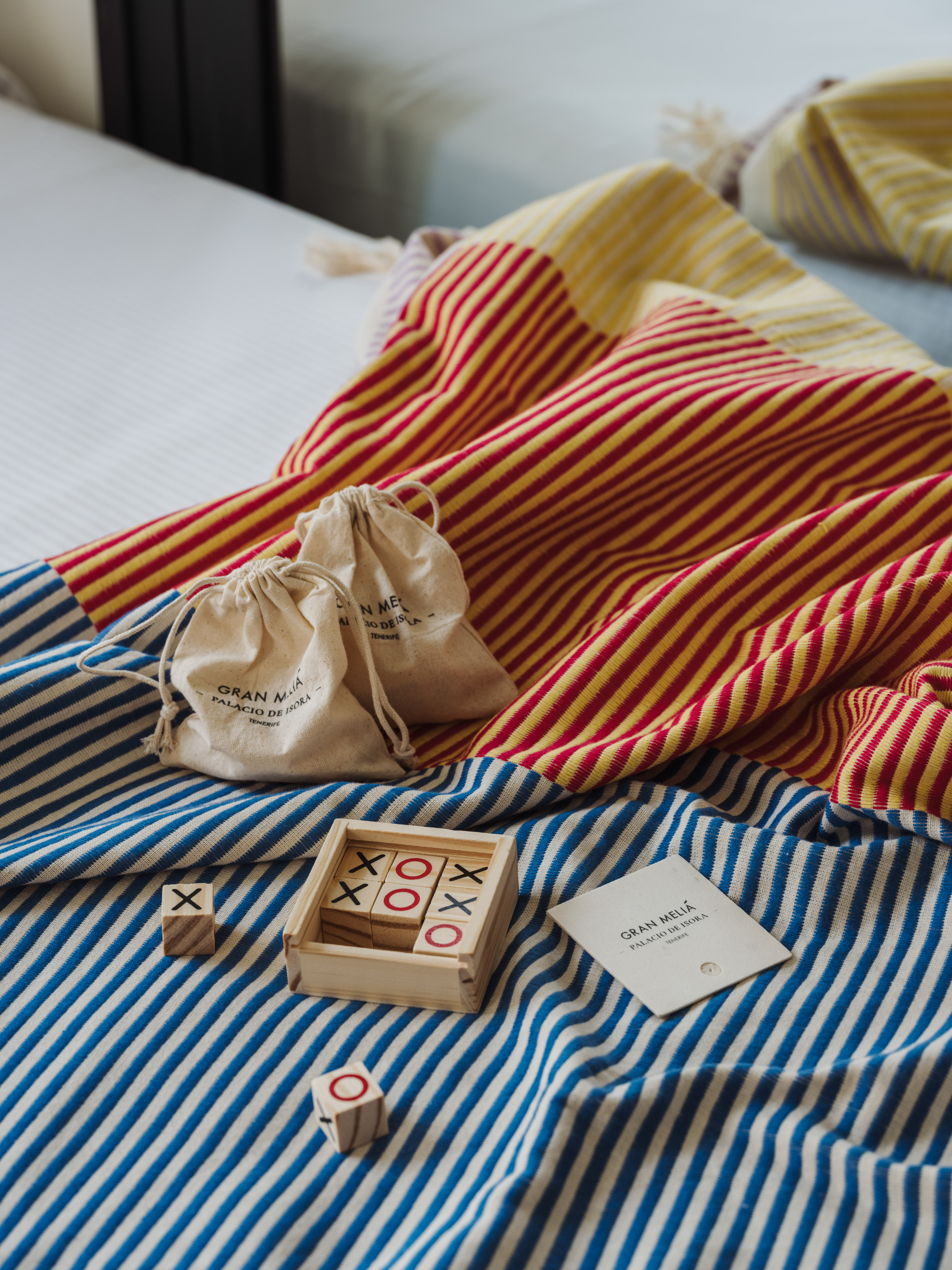 a wooden blocks and bags on a bed