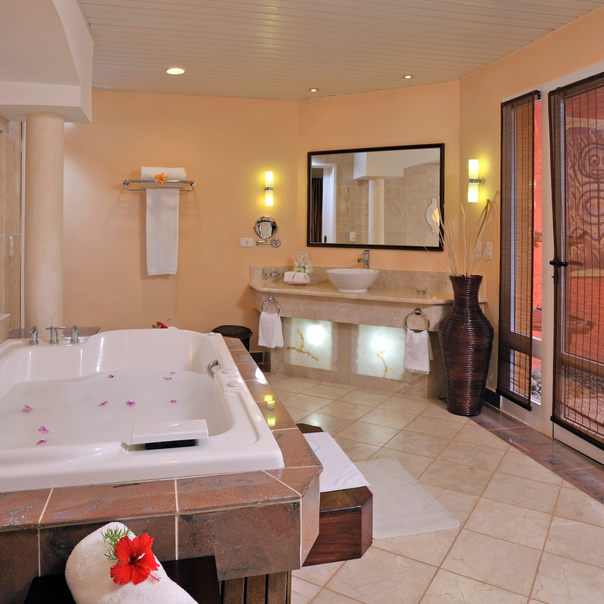 a bathroom with a large tub and sinks