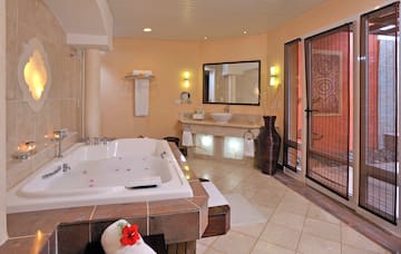 a bathroom with a large tub and sinks