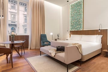 a bedroom with a bed and chair
