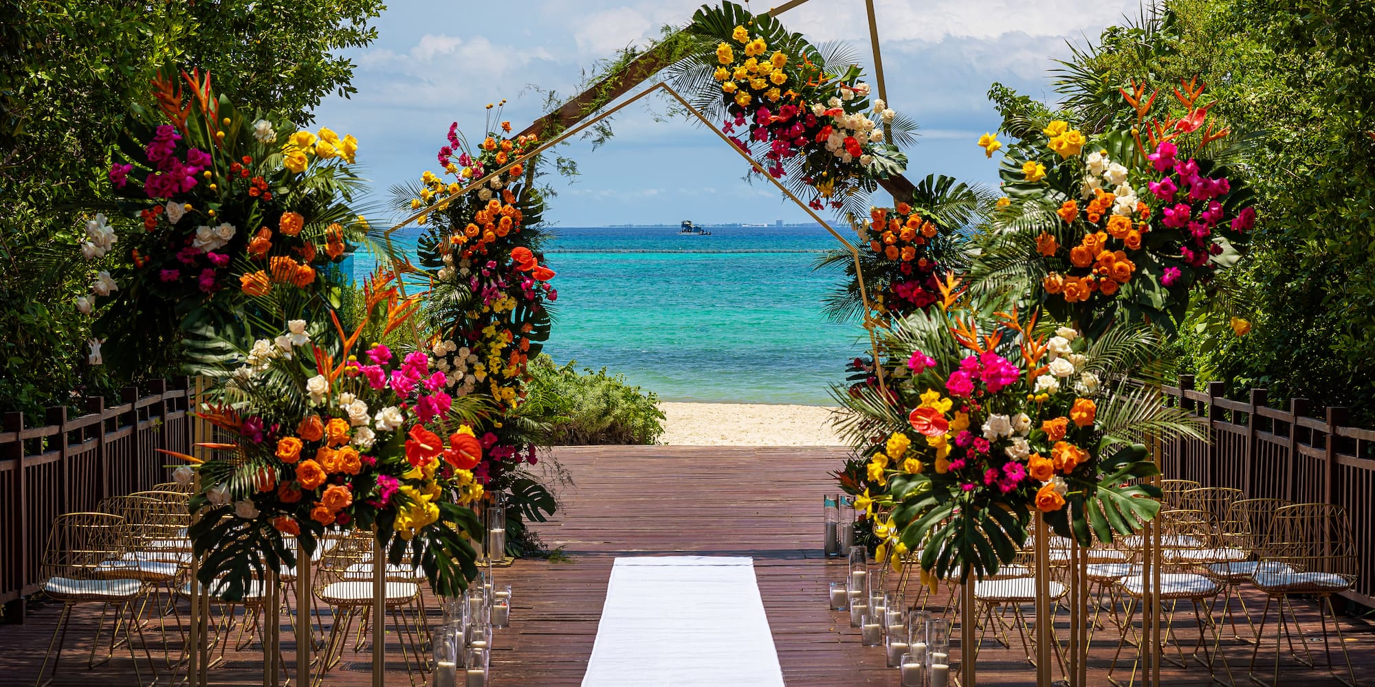 a wedding ceremony with flowers and chairs on a beach