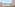 Beachfront balcony with ocean view, palm trees, and outdoor seating.