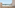Beachfront balcony with ocean view, palm trees, and outdoor seating.