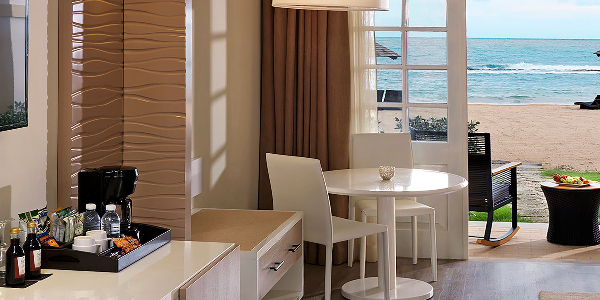 a room with a view of the beach and ocean