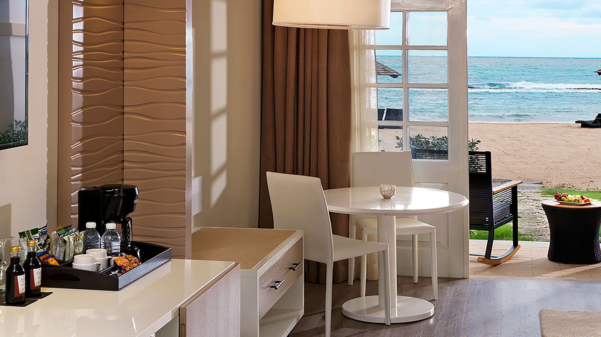 a room with a view of the beach and ocean