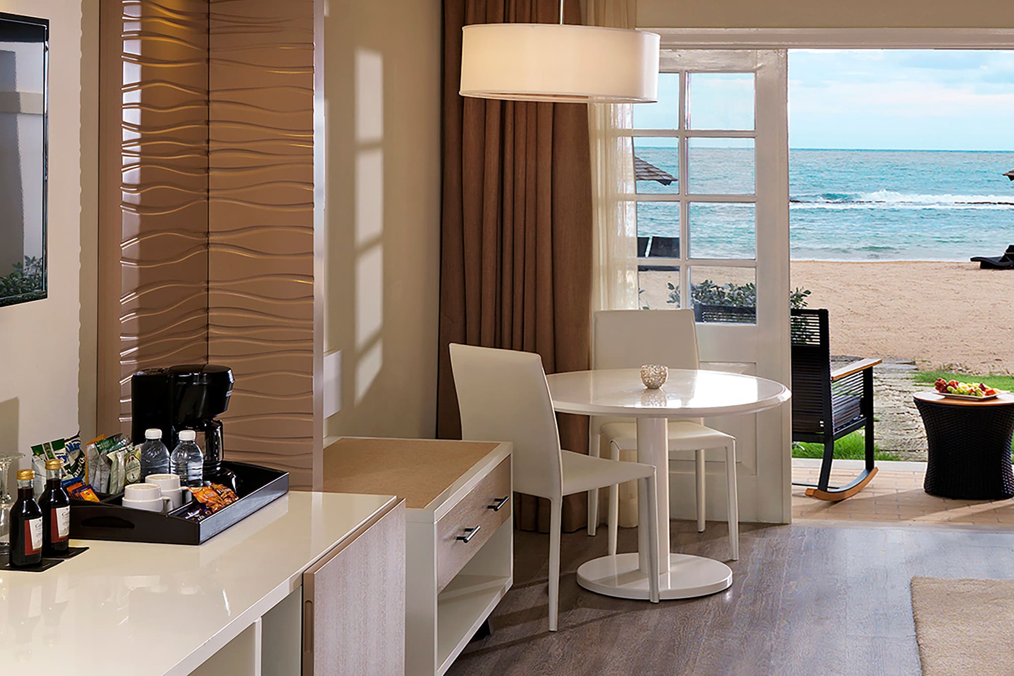 a room with a view of the beach and ocean