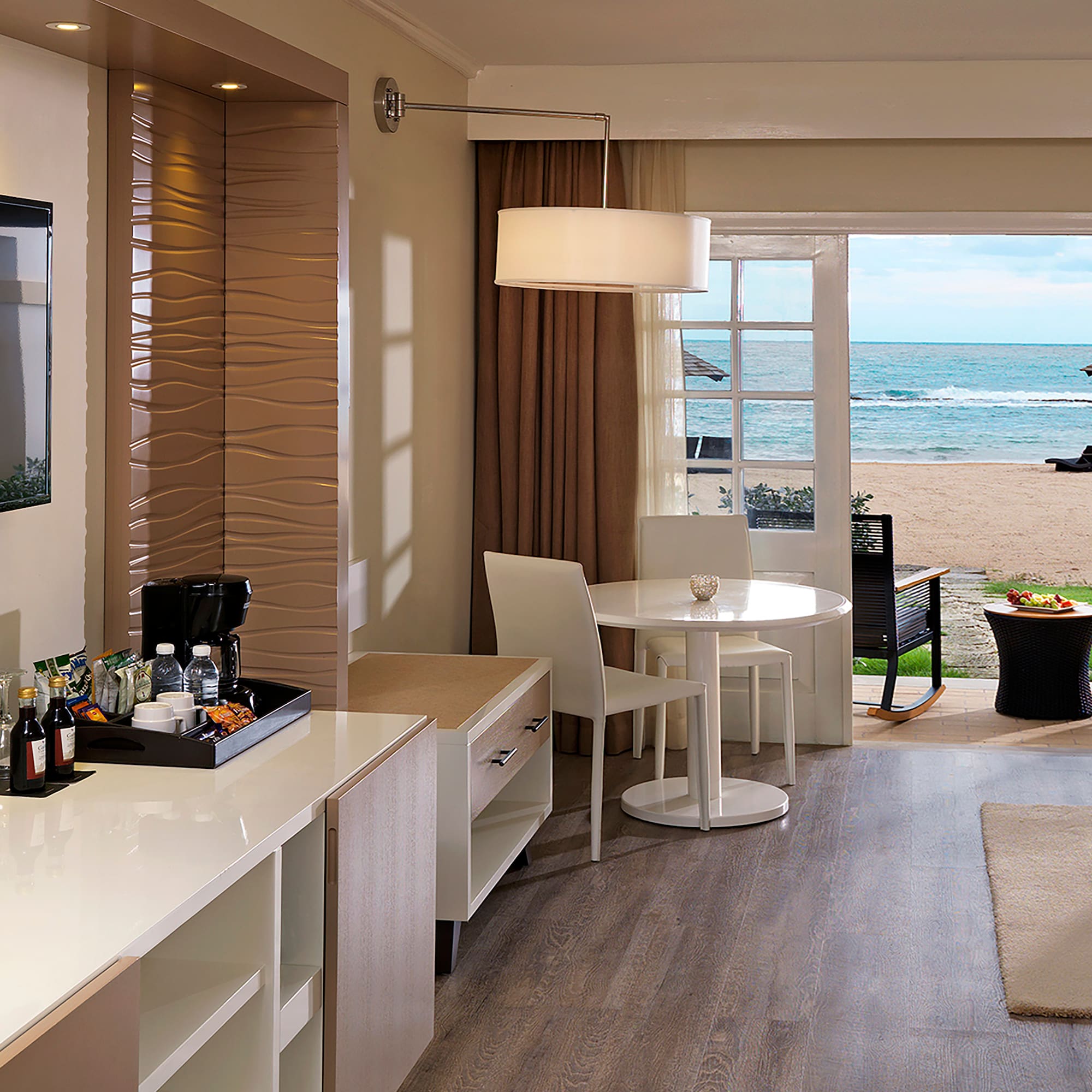 a room with a view of the beach and ocean