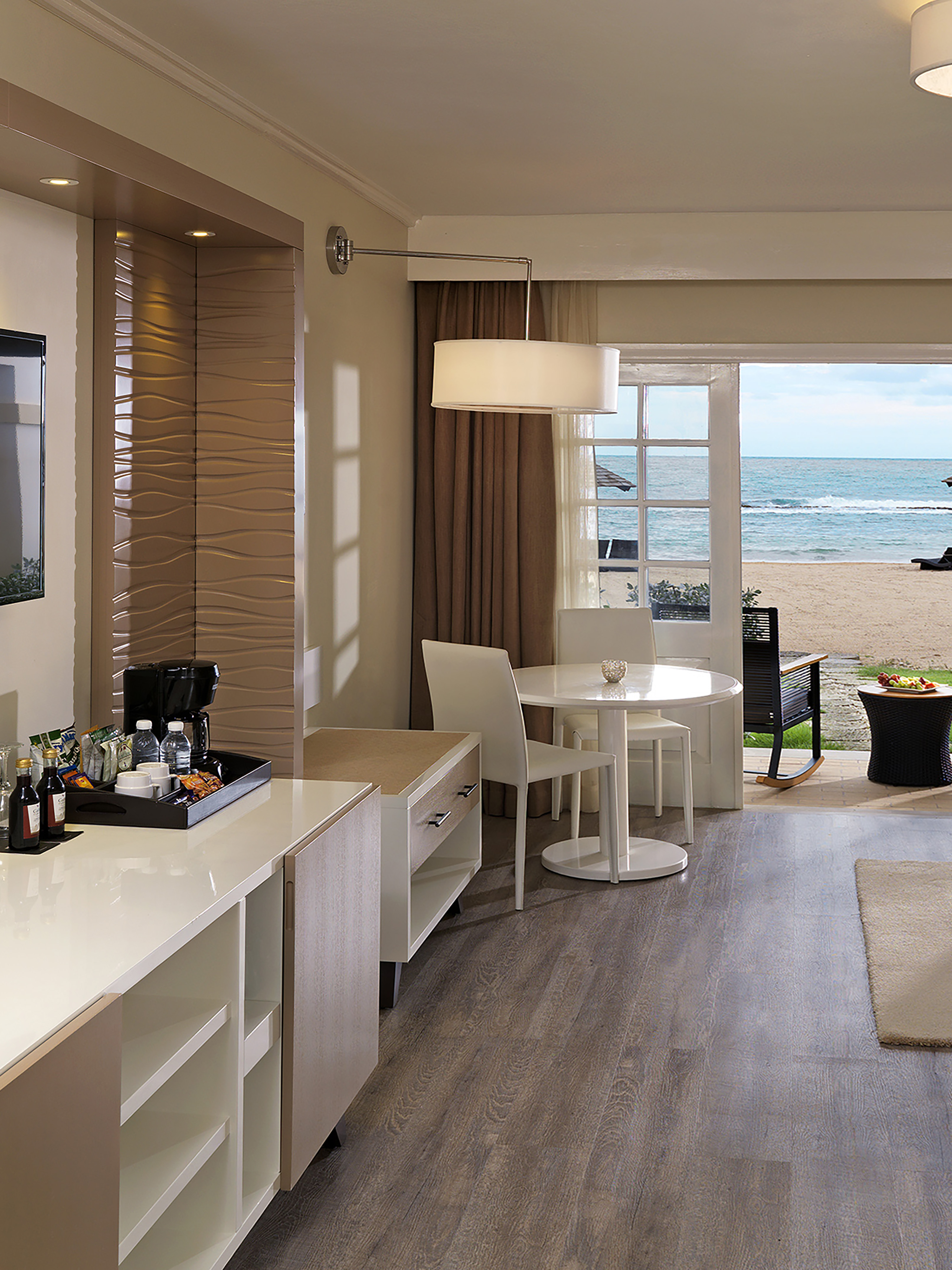 a room with a view of the beach and ocean