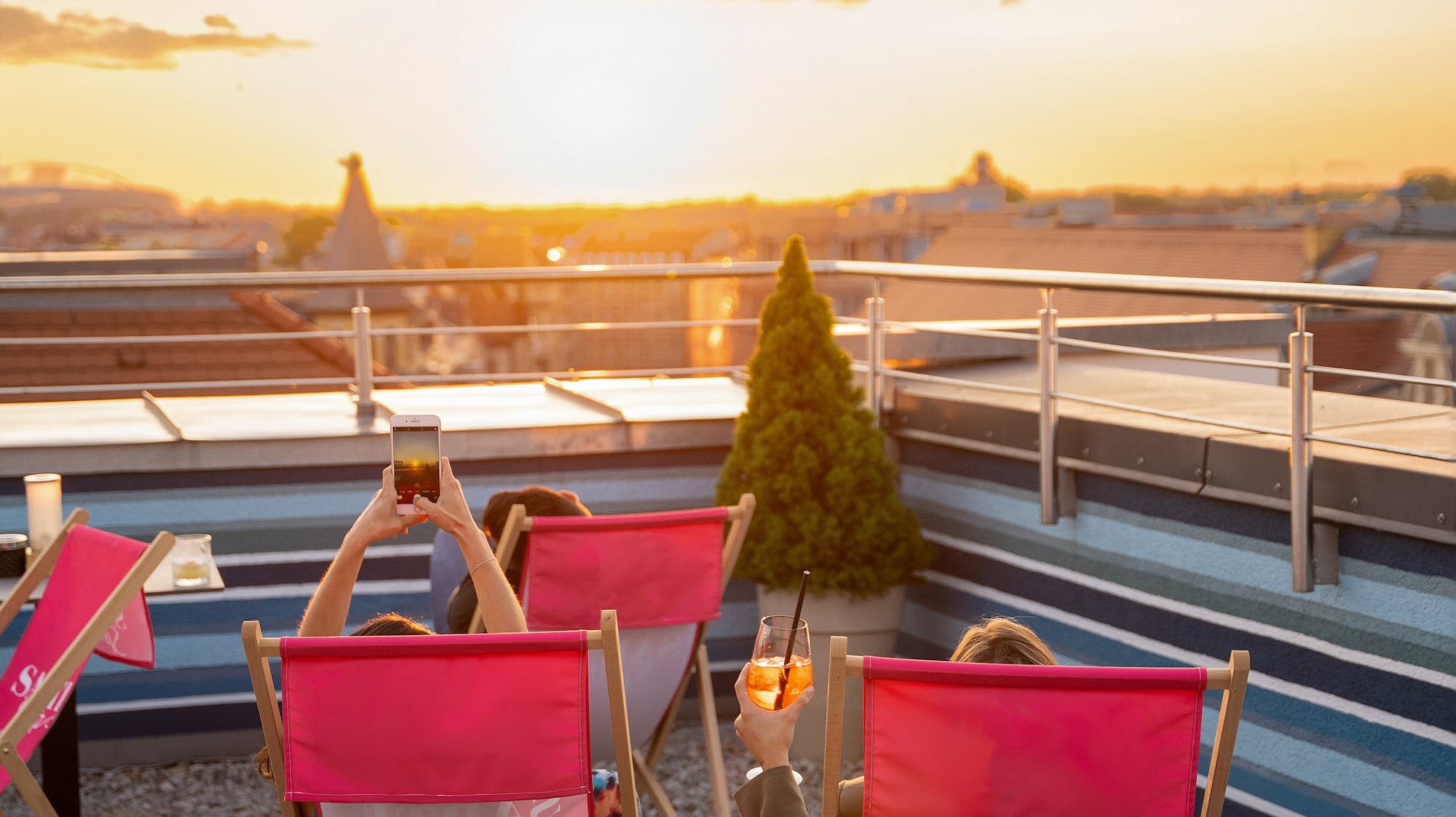 people sitting in chairs on a rooftop