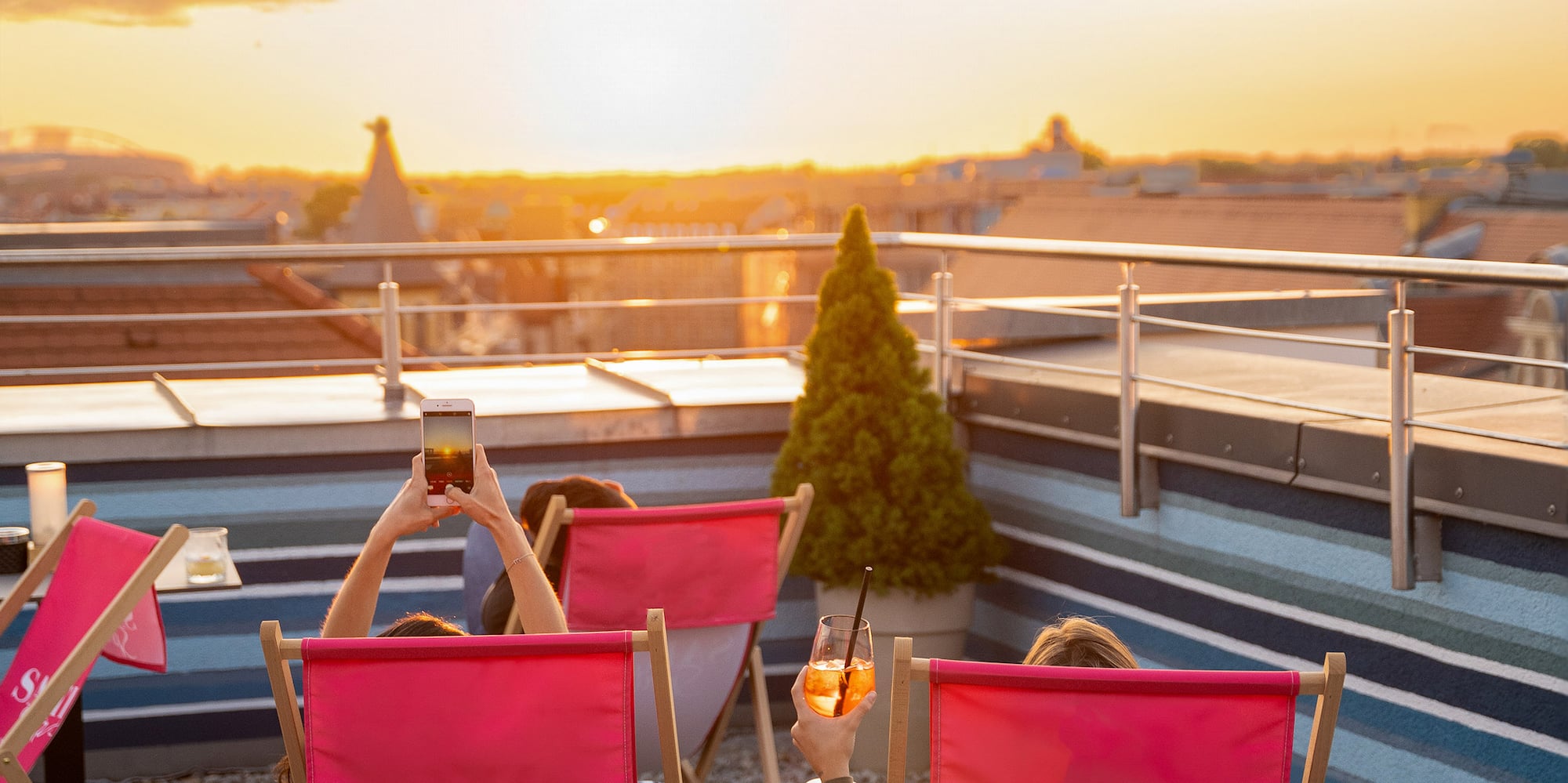 people sitting in chairs on a rooftop
