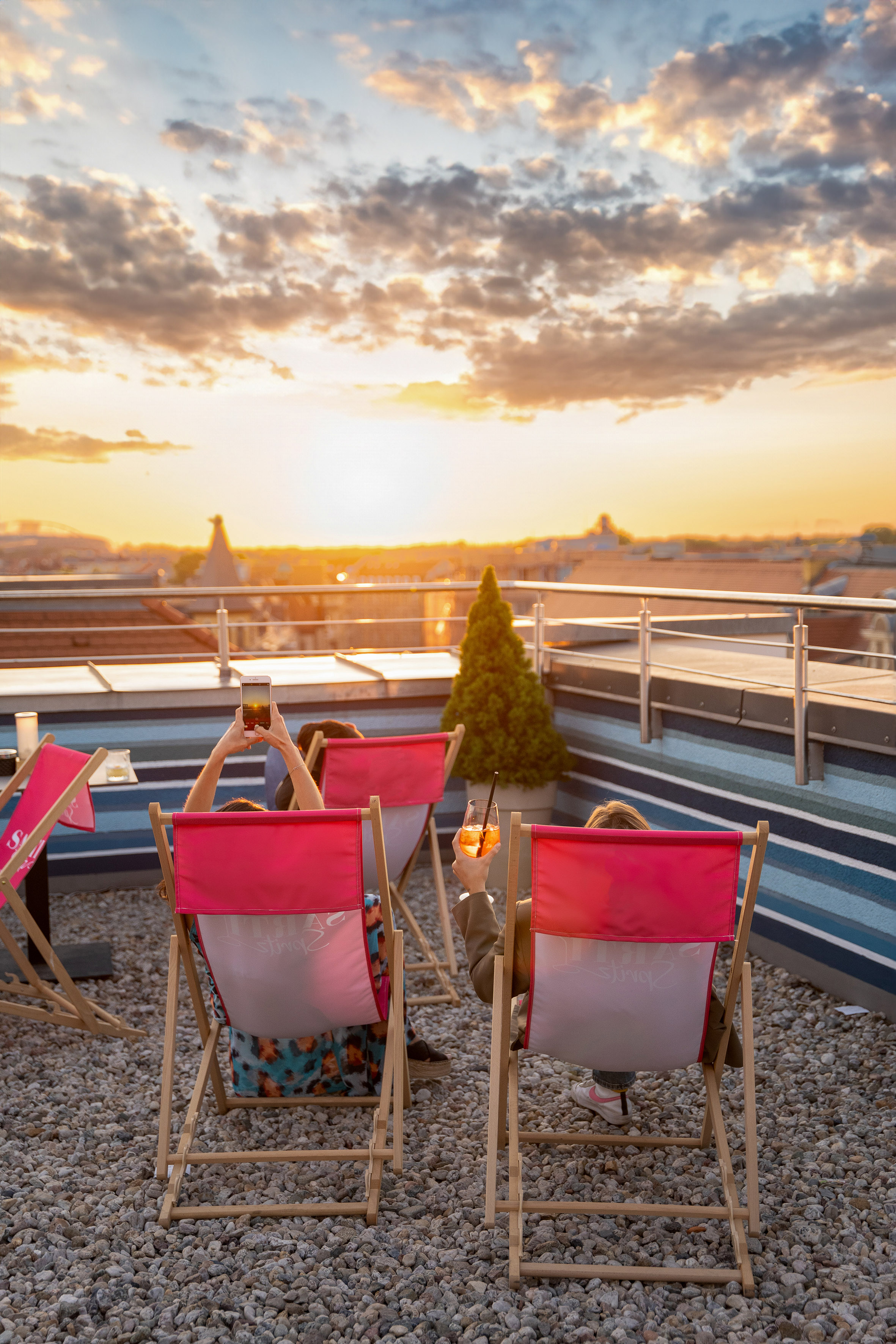 people sitting in chairs on a rooftop