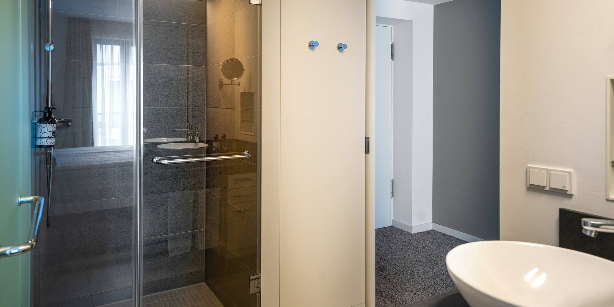 a bathroom with a glass shower and sink