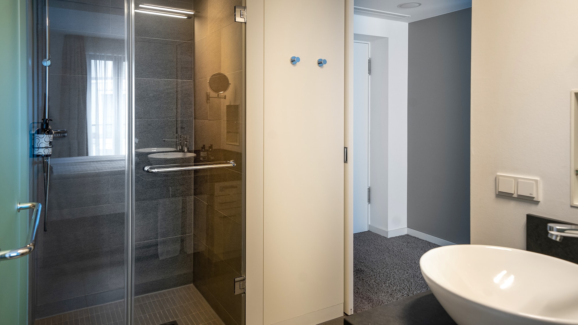 a bathroom with a glass shower and sink