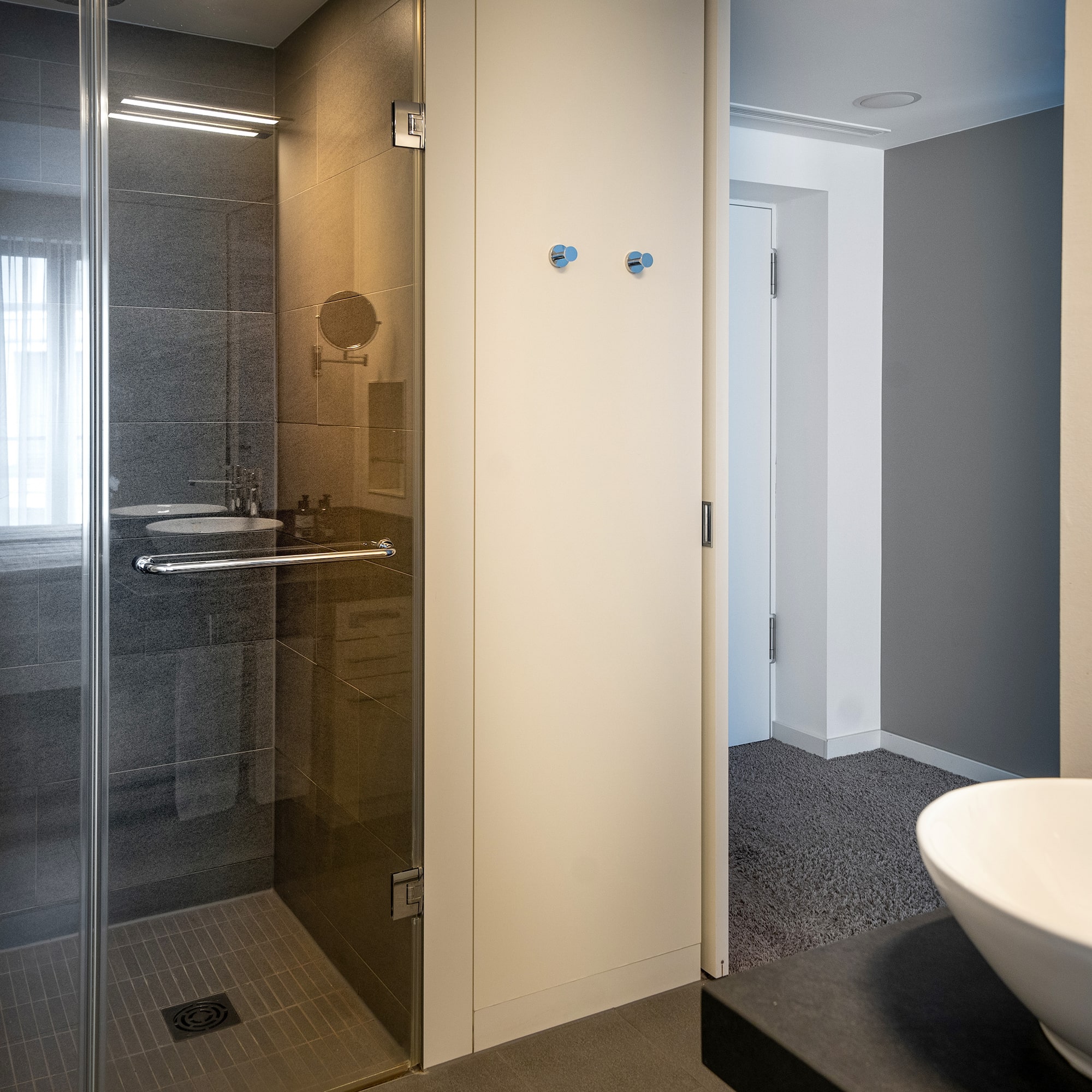 a bathroom with a glass shower and sink